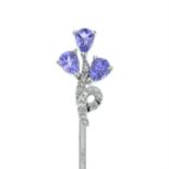 A tanzanite and diamond floral stick pin.