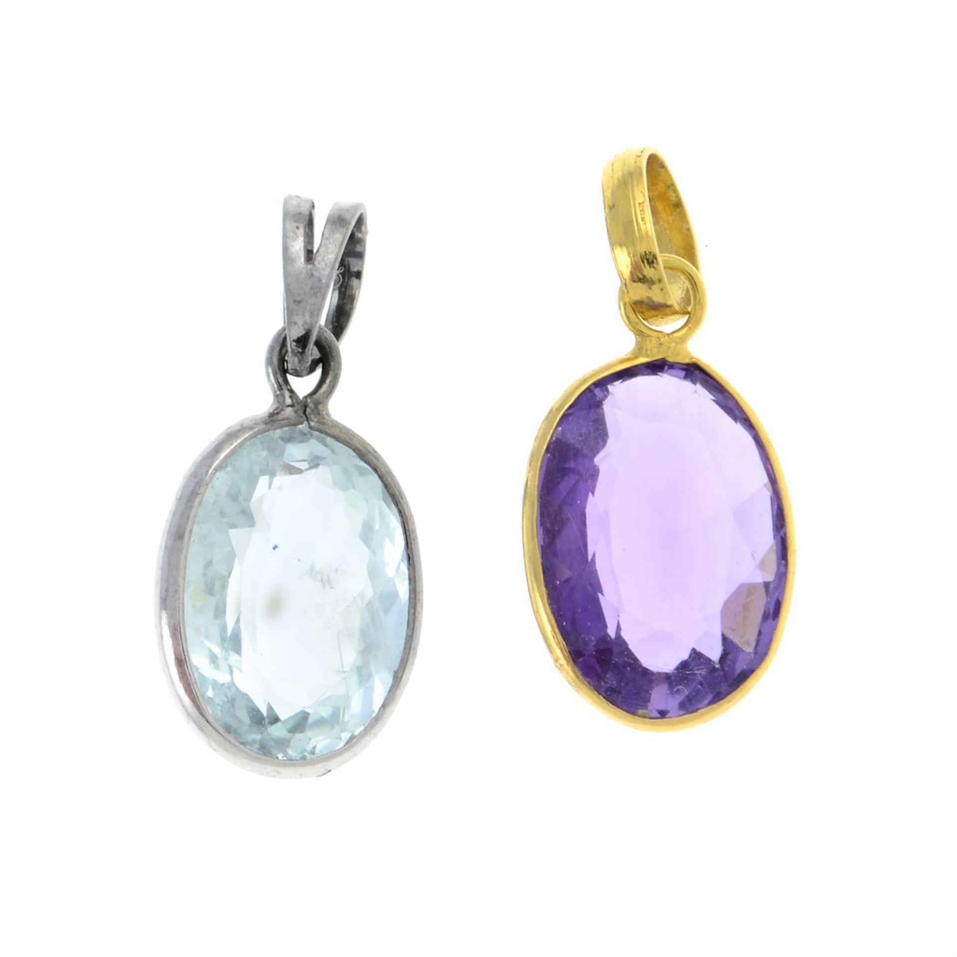 An aquamarine single-stone pendant and an amethyst single-stone pendant.