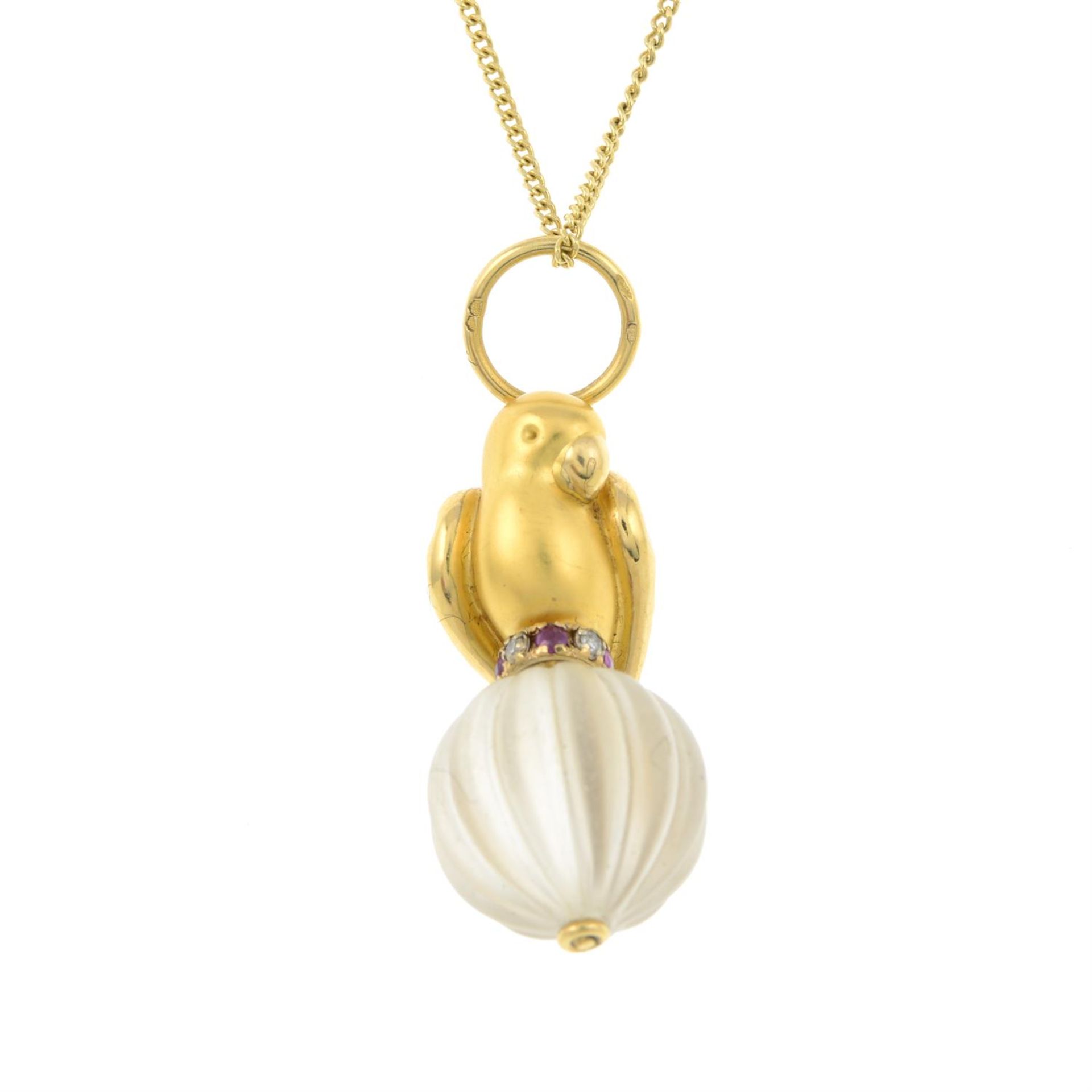 A ruby, diamond and rock crystal parrot pendant, suspended from an 18ct gold chain.