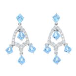 A pair of blue topaz and diamond drop earrings.