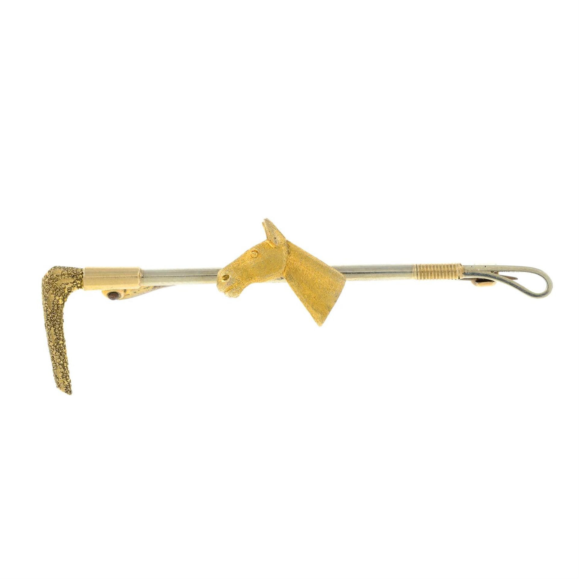 A mid 20th century bi-colour 9ct gold riding crop and horse head bar brooch.