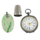 A carved jade pendant, a late Victorian silver thimble and an early 20th century silver pocket