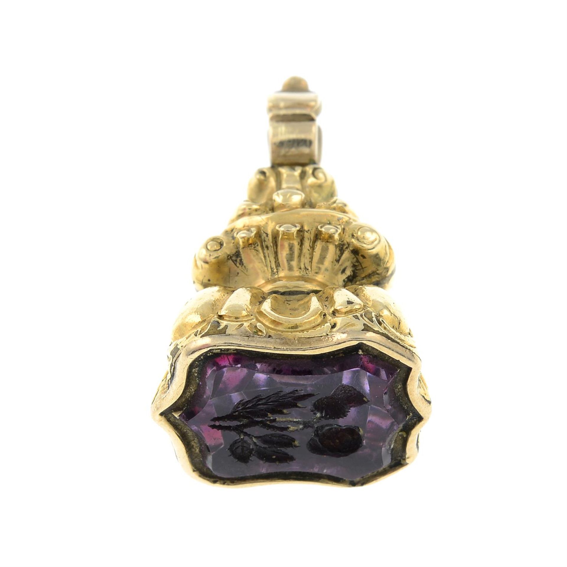 A late 19th century amethyst intaglio fob seal, depicting an entwined thistle and rose.