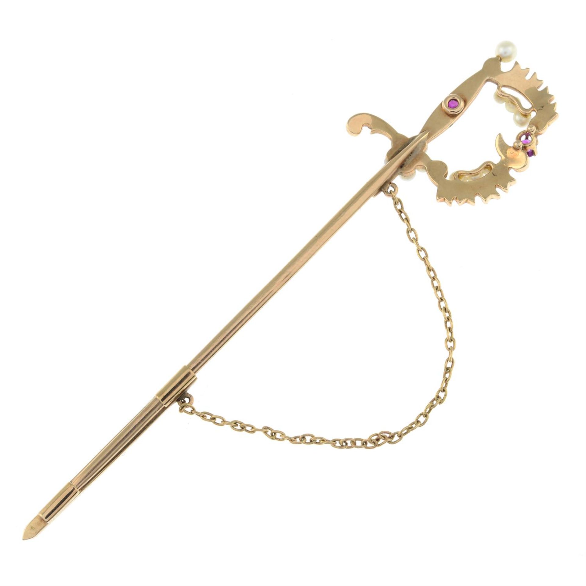 An early 20th century gold ruby and split pearl sword jabot pin. - Image 2 of 2