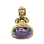A mid 19th century amethyst intaglio fob seal, depicting a butterfly emerging from chrysalis,