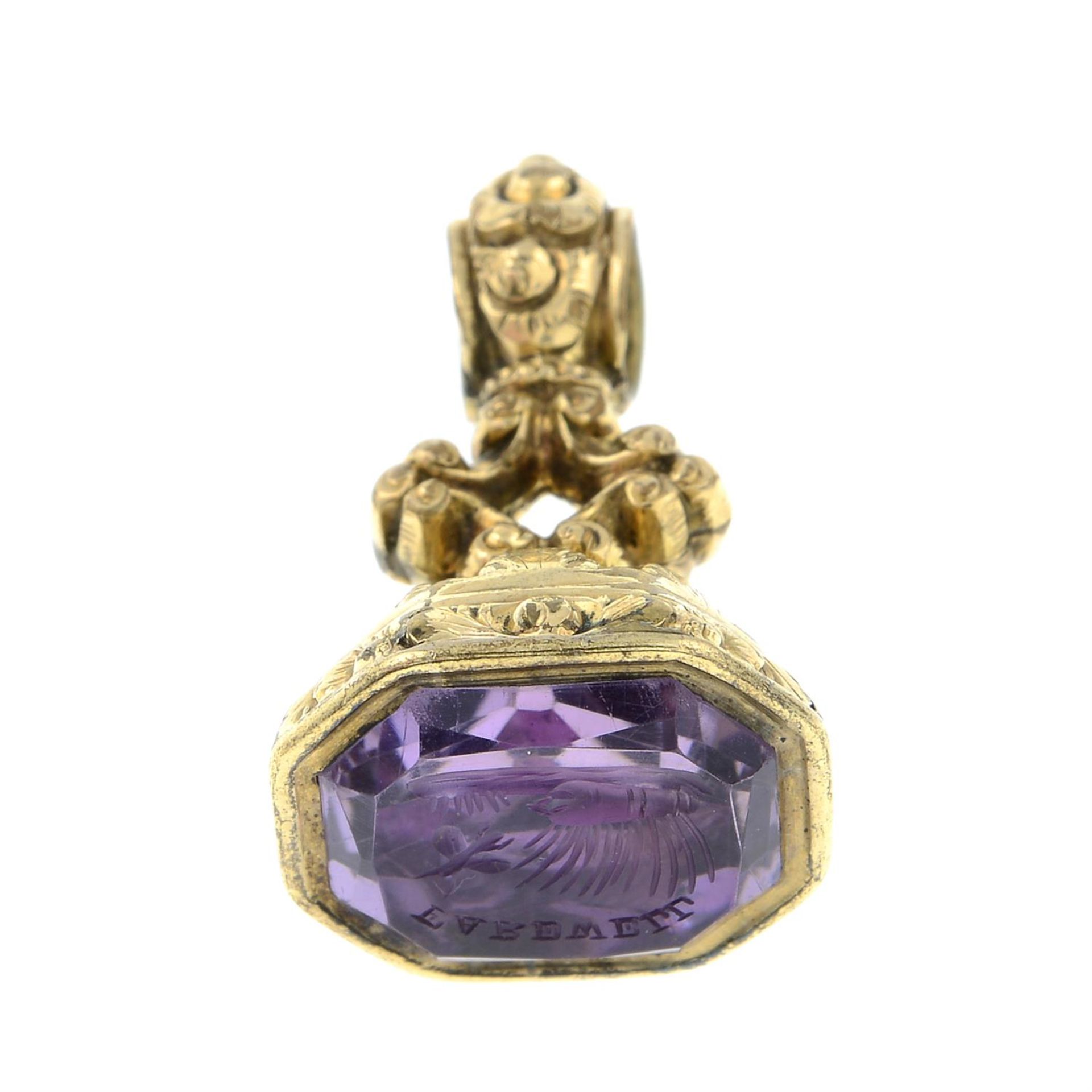 A mid 19th century amethyst intaglio fob seal, depicting a butterfly emerging from chrysalis,