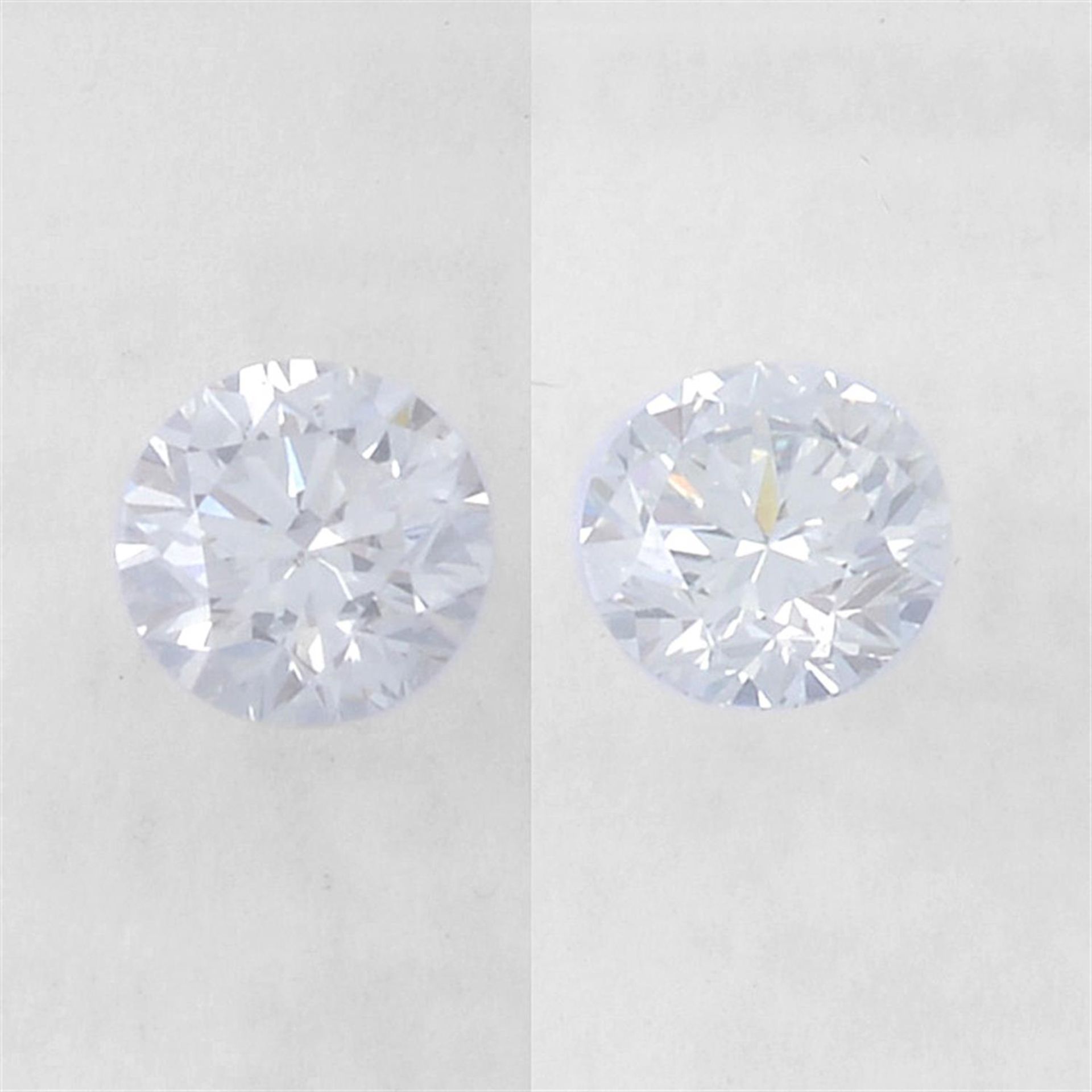 Pair of brilliant cut diamonds, weighing 0.68ct. Within IGI security seal
