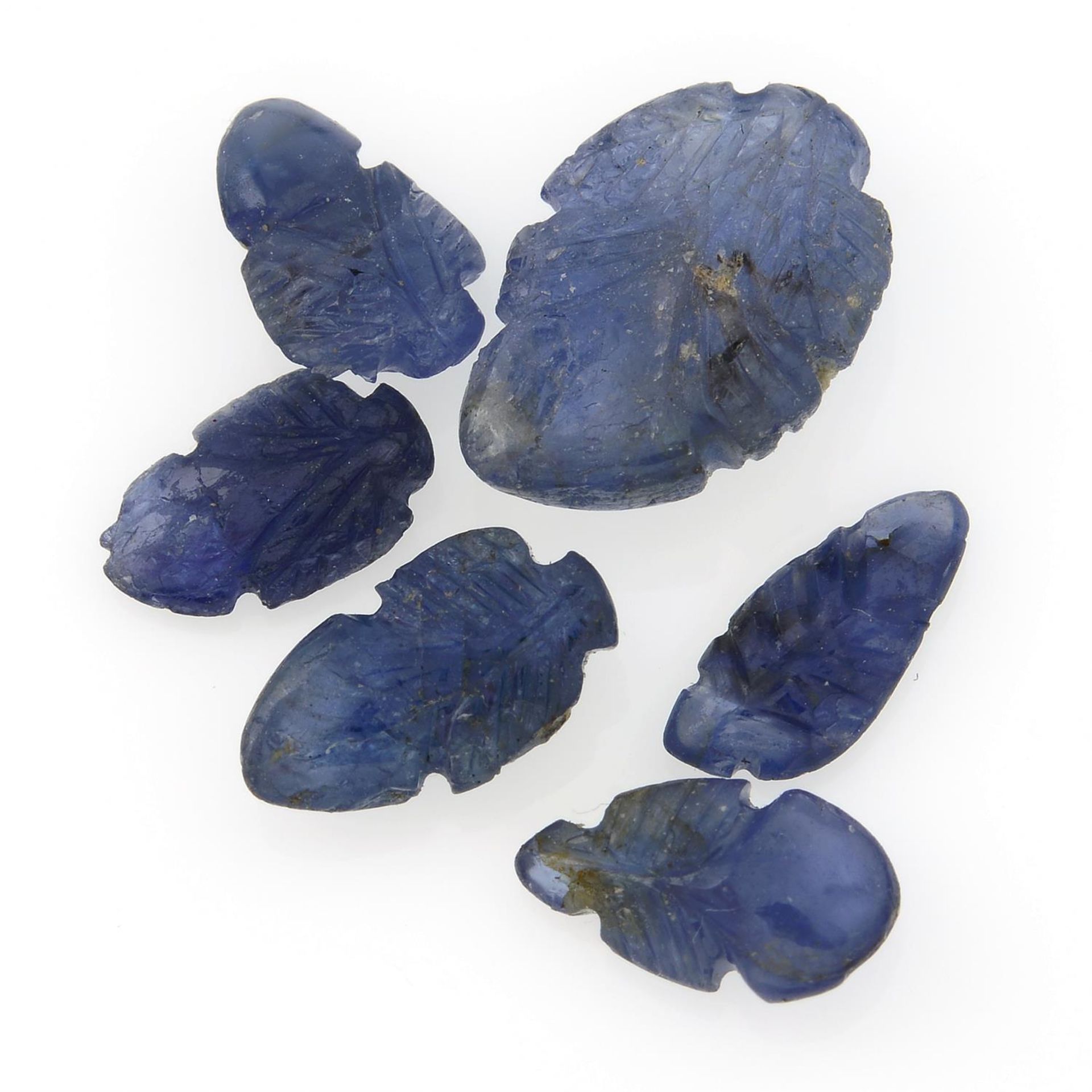 A selection of carved sapphires and oval sapphire cabochons, total weight 24.87cts.