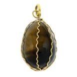 A caged tiger's eye egg pendant.