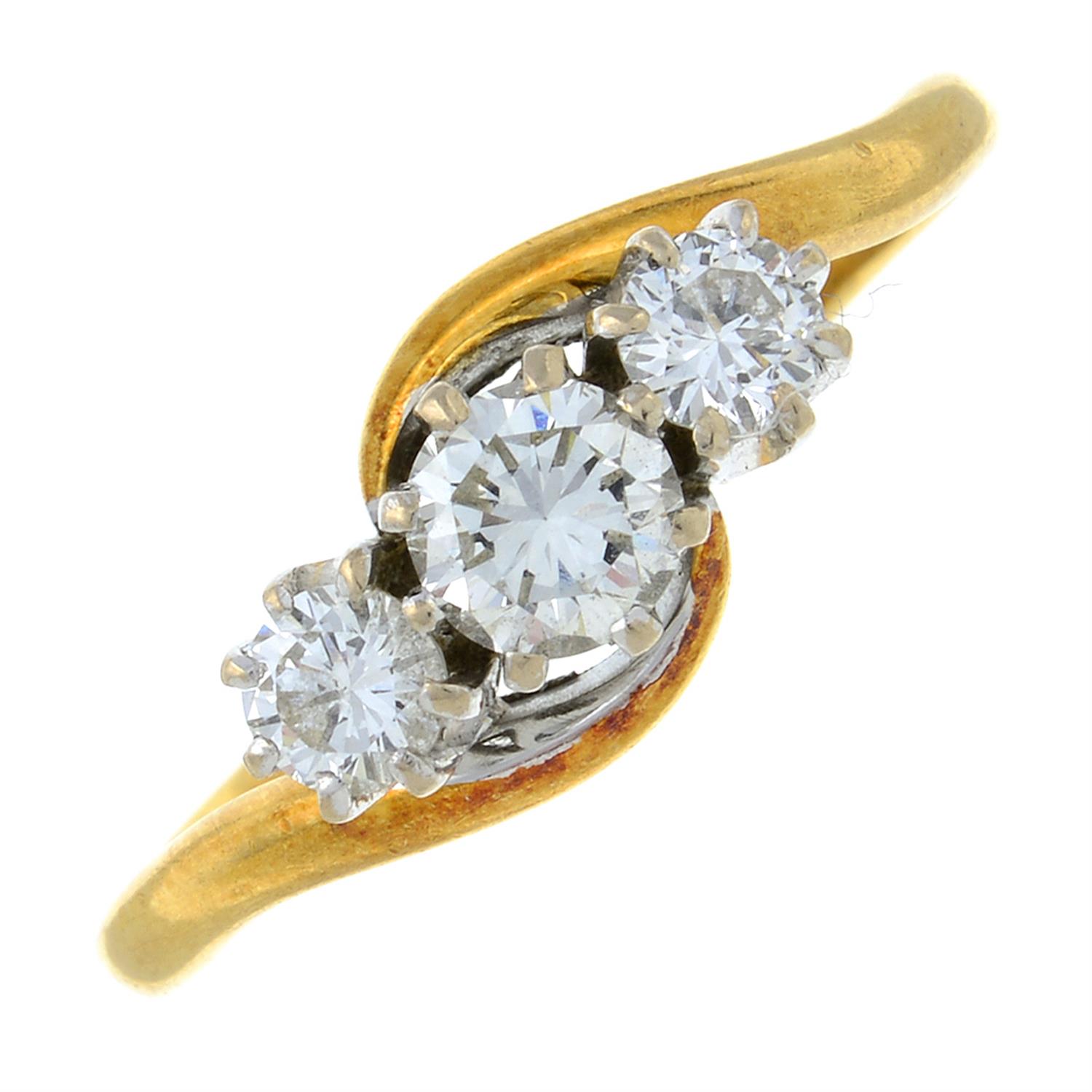 An 18ct gold brilliant-cut diamond three-stone ring.