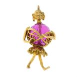 A faceted pink paste bead charm with figural mount.