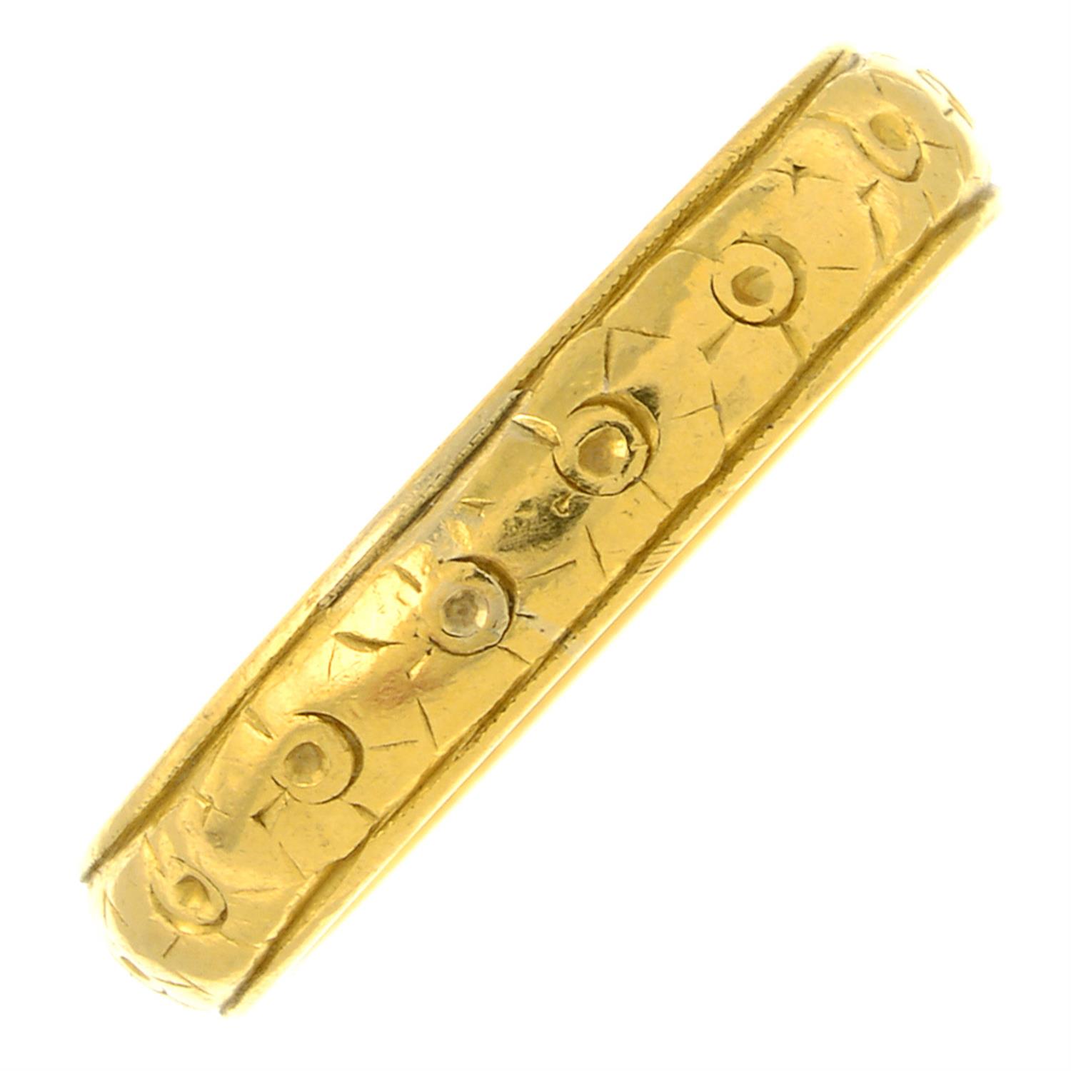 An early 20th century 22ct gold floral band ring.