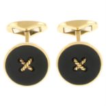 A pair of onyx cufflinks and dress buttons.