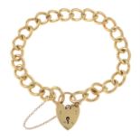 A 9ct gold curb-link chain bracelet, with heart lock clasp.