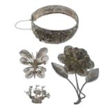 Three filigree brooches and a bangle with safety chain.