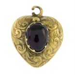 A late 19th century gold garnet heart shape locket. AF.