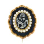 A late 19th century onyx cameo and split pearl brooch, with glazed panel reverse.
