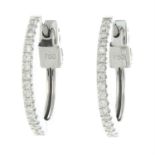 A pair of 18ct gold diamond hoop earrings.