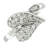 A brilliant-cut diamond leaf crossover ring.