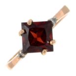 A garnet and brilliant-cut diamond ring.