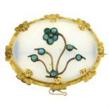 An early 20th century gold chalcedony and turquoise floral brooch.