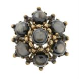 A black star sapphire cluster ring.