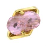 A pink cubic zirconia single-stone ring.