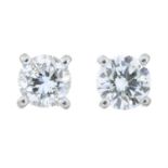 A pair of brilliant-cut diamond stud earrings.