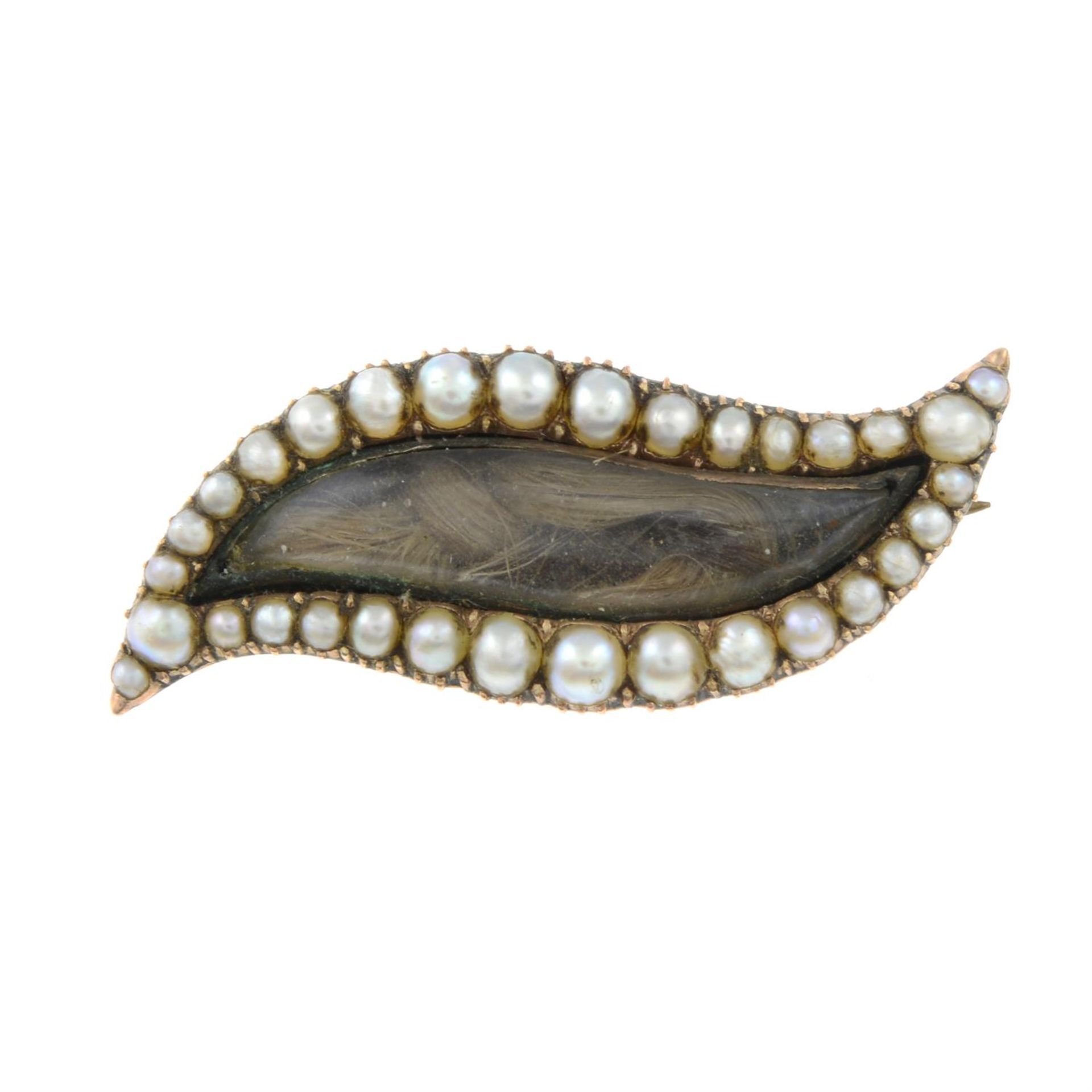 A Georgian 9ct gold split pearl mourning brooch in the shape of an eye.