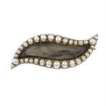 A Georgian 9ct gold split pearl mourning brooch in the shape of an eye.