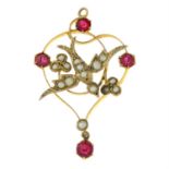 An early 20th century 9ct gold paste and split pearl pendant depicting a swallow.