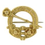 An Edwardian 9ct gold brooch.