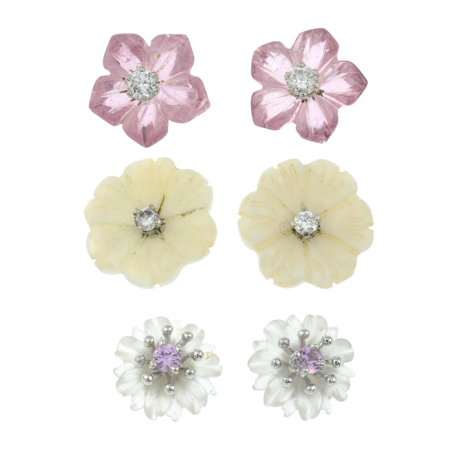 Three pairs of carved gem stud earrings.