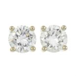 A pair of brilliant-cut diamond stud earrings.