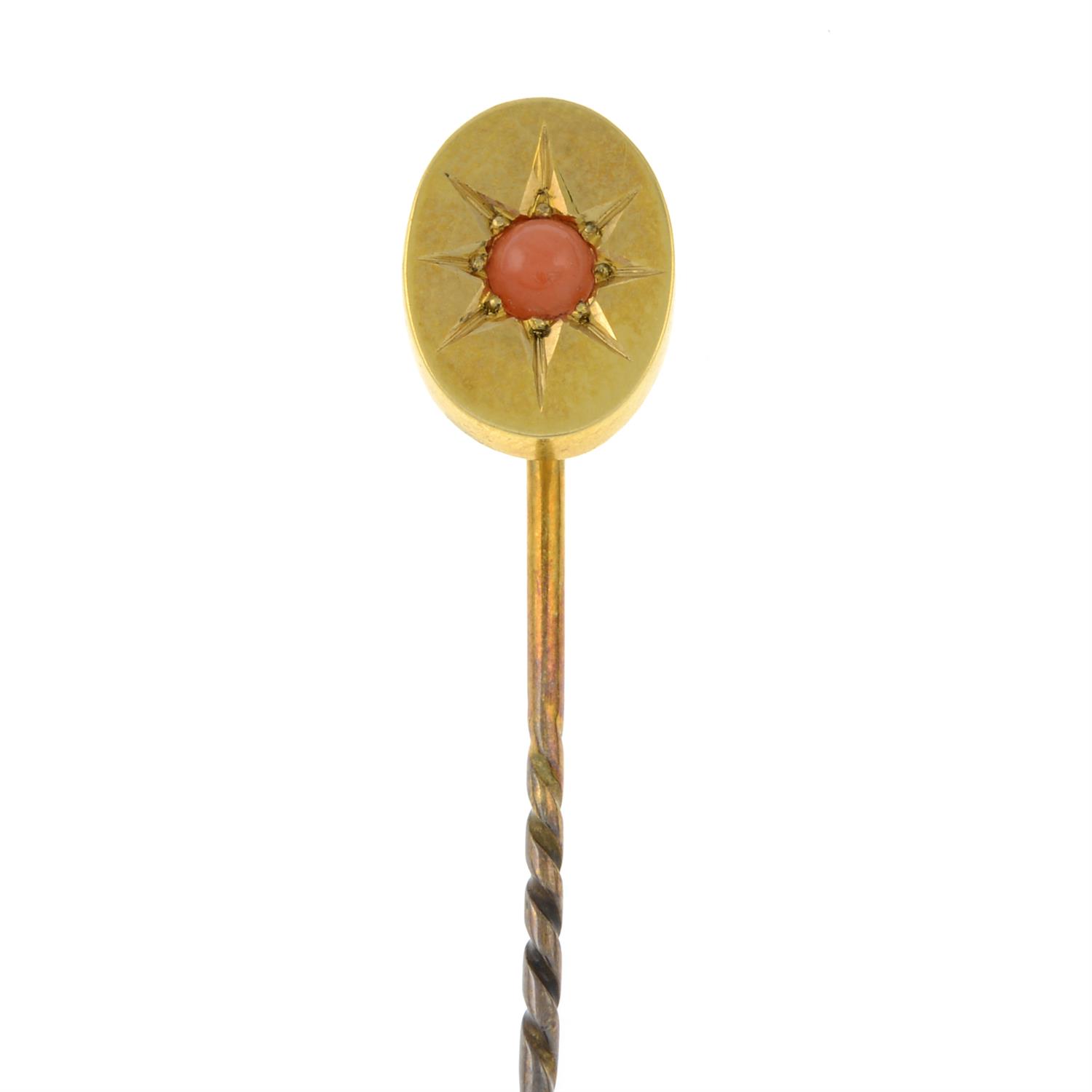 An early 20th century gold coral stickpin.