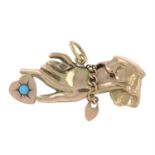 An early 20th century 9ct gold brooch, depicting a hand holding a heart, with turquoise highlight.