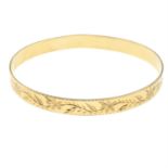 A 9ct gold floral bangle.