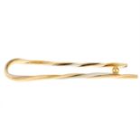 A 'Trinity' tie clip, by Cartier.