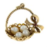 A mid 20th century 9ct gold cultured pearl and orange gem pendant, depicting a basket with four