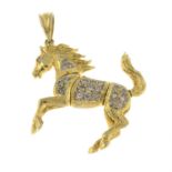 A 9ct gold pink cubic zirconia galloping horse pendant.