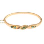 A late Victorian 9ct gold, turquoise and split pearl hinged bangle.