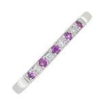 A 9ct gold pink sapphire and brilliant-cut diamond half eternity ring.