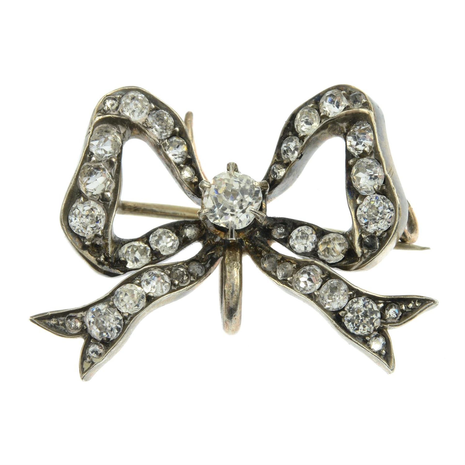 A late Victorian silver colourless paste bow brooch.