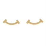 A pair of 'Tiffany T' smile stud earrings.