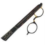 A Victorian tortoise shell lorgnette hand held opera glasses with 9ct gold detailing.