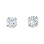 A pair of brilliant-cut diamond single-stone stud earrings.