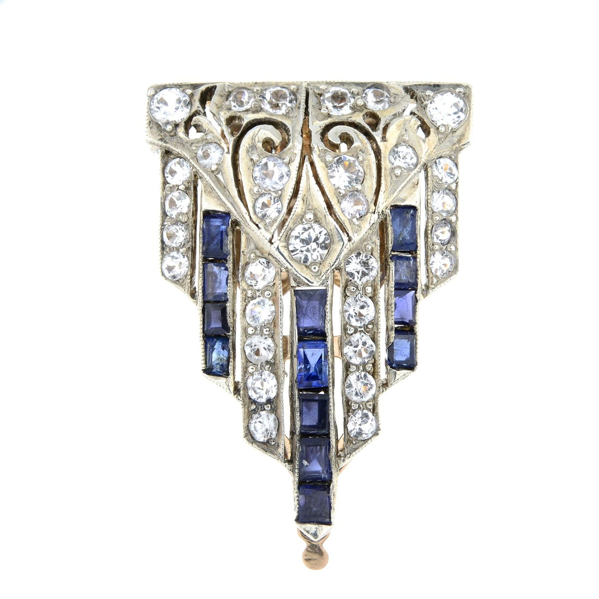 An Art Deco silver and gold, blue and colourless sapphire dress clip.