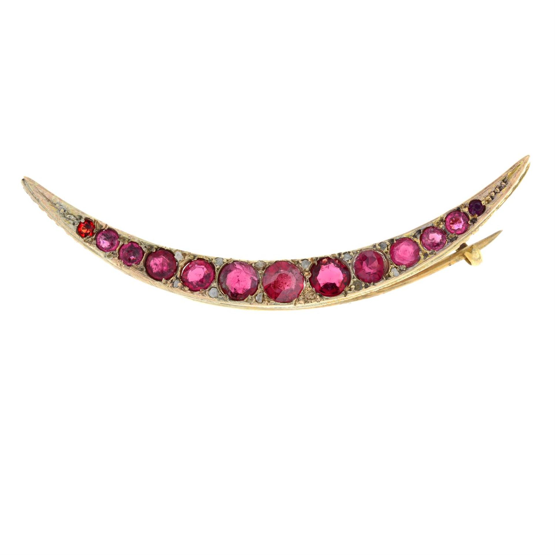 An Edwardian 9ct gold red paste and diamond point crescent brooch. AF.