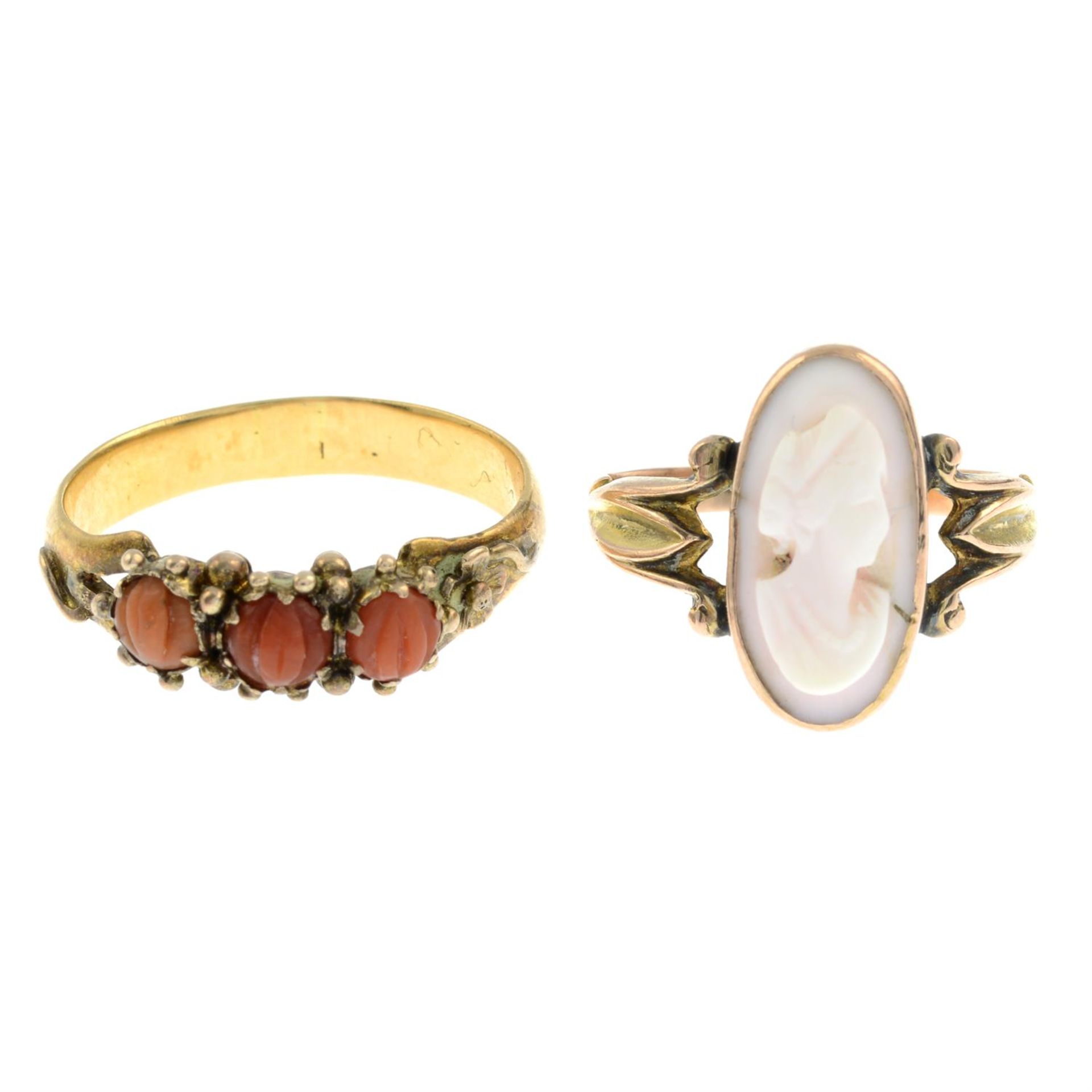 A carved cameo ring and a coral three-stone ring.