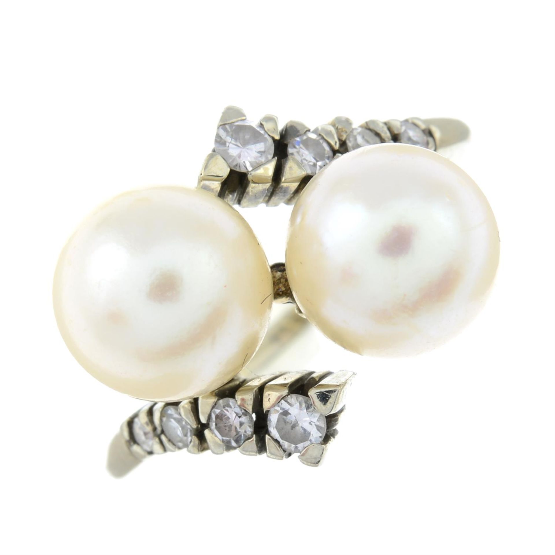 A cultured pearl and diamond crossover ring.